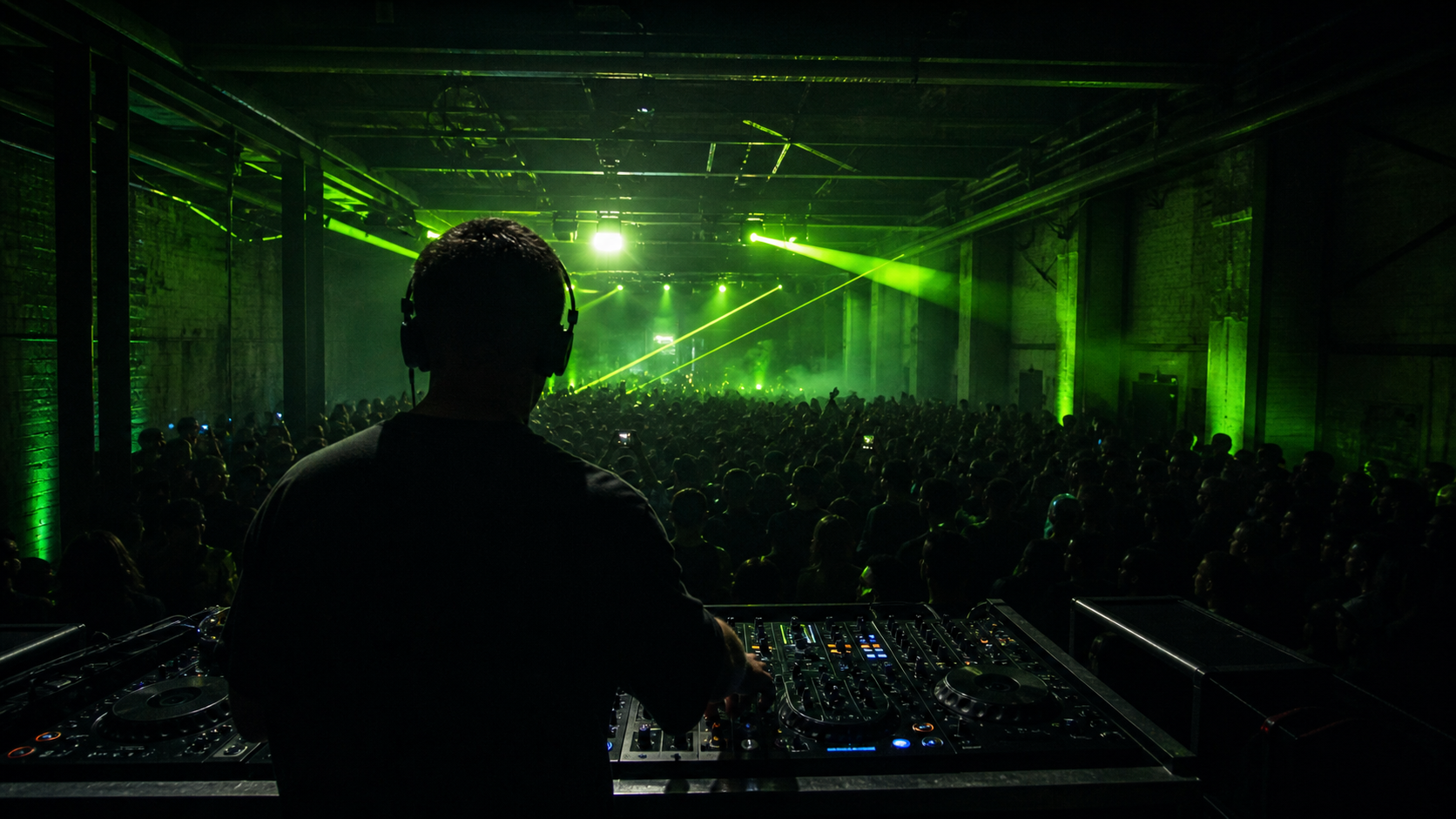 DJ performing to an underground warehouse crowd